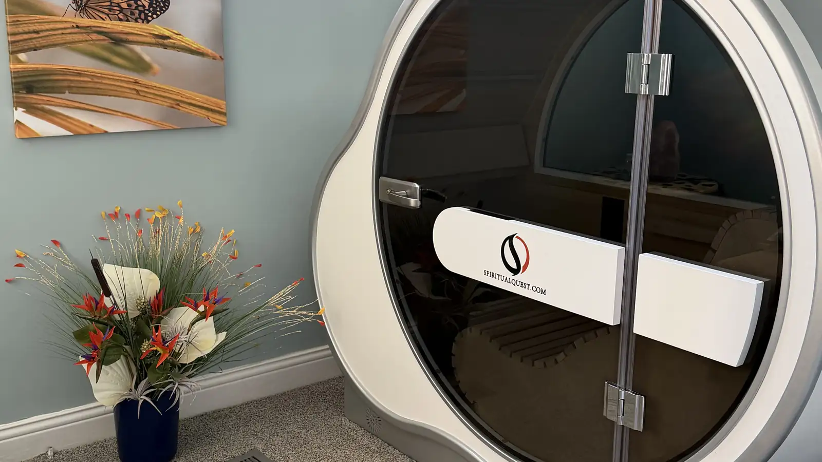 The OxyBoost cabin's curved glass door, with the reclined bench visible inside.