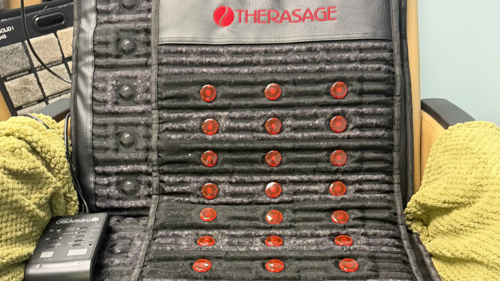 The TheraPro mat on a reclining chair in the Restore Room, its red lights on.